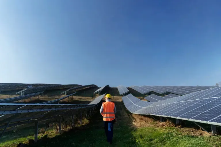 Project manager walking a ground mount solar site during construction