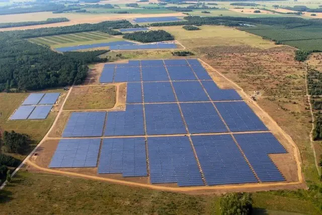 Aerial view of a solar site boundary with array blocks laid out across the available land parcel